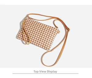 Top-down view of woven small crossbody bag with brown and white checkered pattern detail