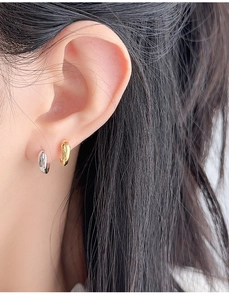 Close-up of polished S925 sterling silver hoop earrings in gold and silver finishes