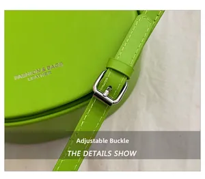 Macro detail of bright green leather saddle bag with adjustable silver buckle