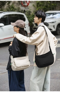 Waterproof nylon messenger bags in beige and black shown on models in urban street style