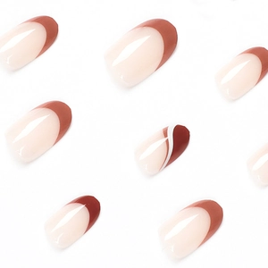 Brown French wavy press-on nails in nude pink and caramel finish on a white background