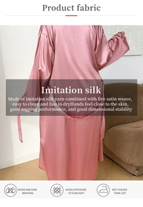 Close-up of pink satin long robe with smooth texture and delicate back tie detail