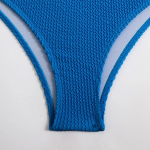 Detail of high-waist bikini bottom in blue smocked fabric with premium white lining