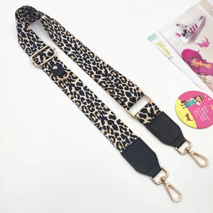 Adjustable leopard print phone strap with gold hardware and black leather ends