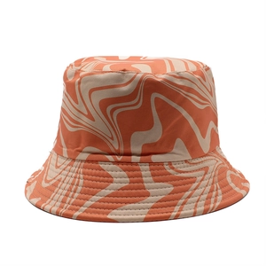 Detailed view of bucket hat with orange and beige marble pattern on canvas fabric