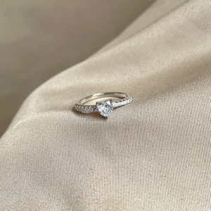 Macro detail of S925 sterling silver ring with heart-shaped zircon and side stones