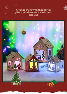 Detailed view of LED glowing wooden Christmas house set with deer and snowman motifs