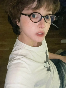 Detailed view of American retro Y2K tortoise shell oval glasses worn by a female model