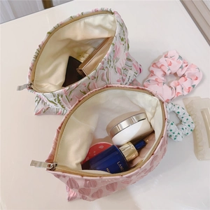 Detailed interior of a pink heart pattern makeup bag showing storage capacity and zipper