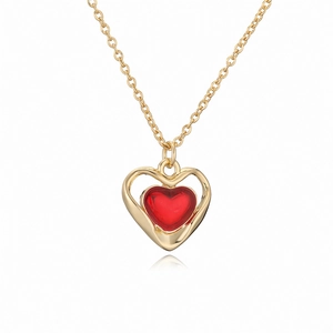 Vintage gold O-chain necklace featuring a red enamel heart pendant on a white background