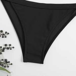 Detailed macro view of black bikini bottoms featuring durable double-needle stitching