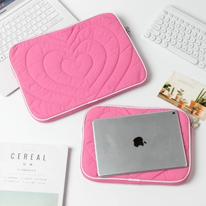 Detail view of quilted heart pattern on rose red iPad sleeve and laptop case