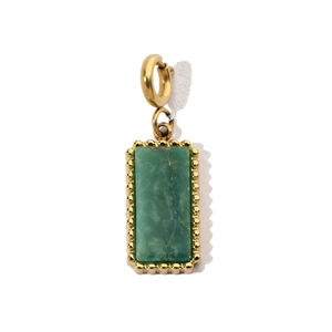Detail of a rectangular green natural stone pendant with a gold beaded border and clasp