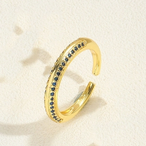 Detail of adjustable gold ring featuring two rows of micro-set blue gemstones
