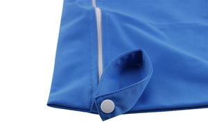 Detailed close-up of blue plain fabric diaper bag with silver snap and zipper closure