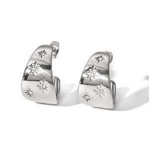 Silver-plated C-shaped earrings with star-patterned crystals on a white background