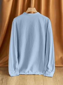 Detailed back view of light blue linen shirt showing breathable fabric texture and stitching
