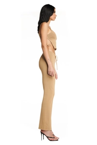Side view of model wearing a khaki knit two-piece set with a crop tank top and high-waist pants