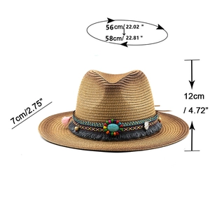 Brown straw cowboy hat with turquoise ethnic band and tassels, white background
