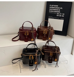 Detailed close-up of compact vanity case handbags in four colors with vintage gold hardware