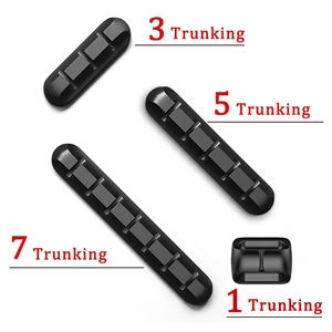 Set of black silicone cable organizers with 1, 3, 5, and 7 slots for USB wire management