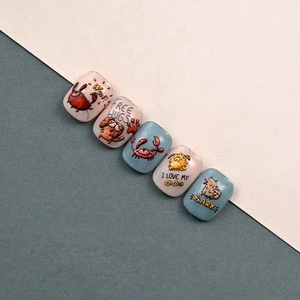 Detail showing 5D embossed nail stickers with cute cartoon dog and crab patterns