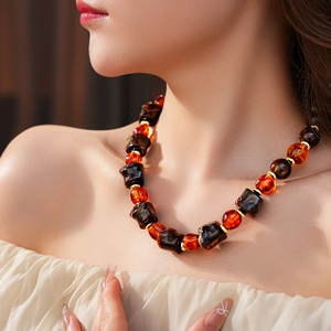 Close-up of irregular amber beads and gold accents on a vintage collar necklace