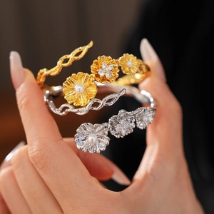 Detail of vintage zircon pearl flower bracelet in gold and silver finish on hand