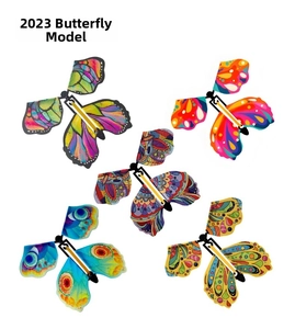 Detail showing five colorful wind-up flying butterfly toys with elastic power bands