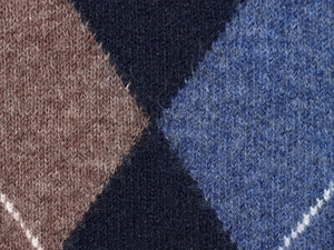 Detailed macro view of the soft argyle knit fabric in brown, navy, and light blue
