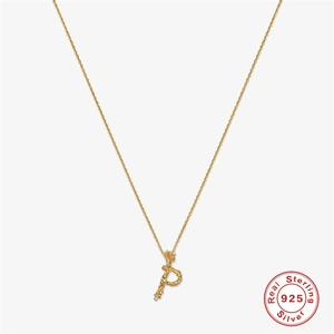 Macro shot of 925 sterling silver gold plated pendant with textured letter P design