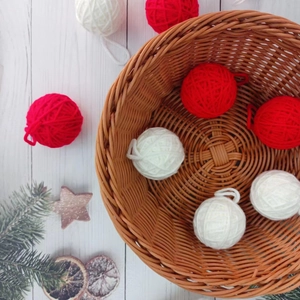 Red and white 5cm yarn ball Christmas ornaments in a rustic woven basket setup