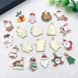 Detail of Christmas enamel alloy charms featuring Santa, reindeer and snowman for DIY jewelry