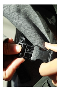 Detail of the durable plastic buckle and nylon strap adjustment on a work apron