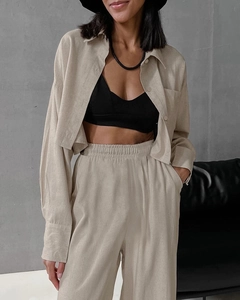 Close-up of beige linen long-sleeve shirt and drawstring pants set for women