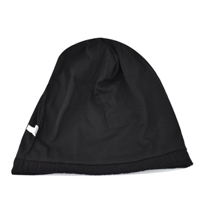 Detail shot of black knitted beanie interior showing washing label and fine ribbed edge
