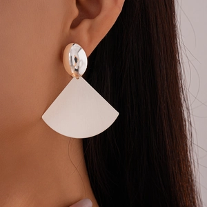 Detail view of silver geometric earrings with a matte white fan-shaped drop design