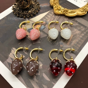Detailed view of handmade strawberry drop earrings in four colors with pearl bead seeds
