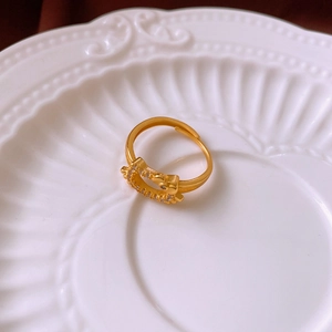 Macro view of gold plated flower cat ring with cubic zirconia crown detail