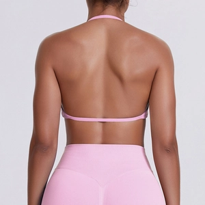 Back view of a pink seamless sports set featuring a halter open-back bra and leggings