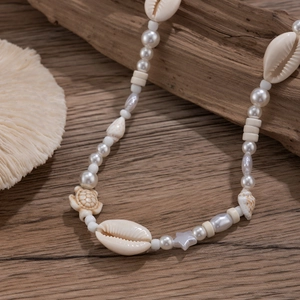 Men's hip-hop shell and pearl necklace with turtle and starfish charms on wood