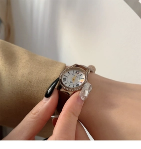 Close-up of elegant women's watch with shell dial, roman numerals and brown leather strap