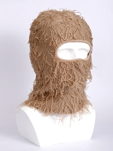 Macro detail of khaki knitted balaclava showing fluffy fringe and warm wool texture