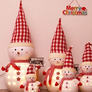 Illuminated Christmas snowman figurines with red plaid hats and warm LED lights