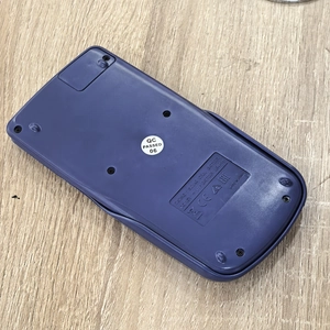 Rear view of scientific calculator showing CE/EAC certification and battery specs