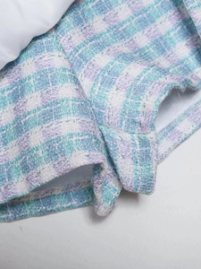 Detailed macro shot of blue and white textured tweed fabric with fine weaving craft