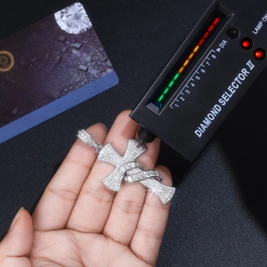 Diamond tester testing s925 silver cross pendant with GRA moissanite certificate