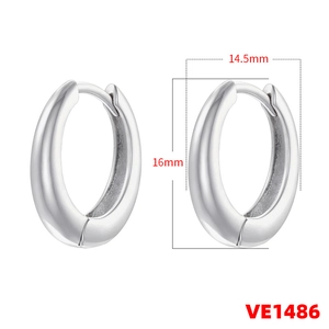Detail view of silver oval hoop earrings with size measurements of 14.5mm and 16mm