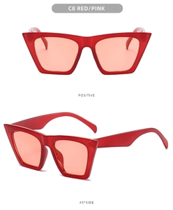 Detail view of bold red square sunglasses with gradient pink lenses and chunky frame