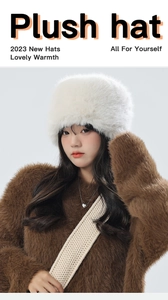 Close-up of white plush thermal trapper hat with soft faux fur texture for winter